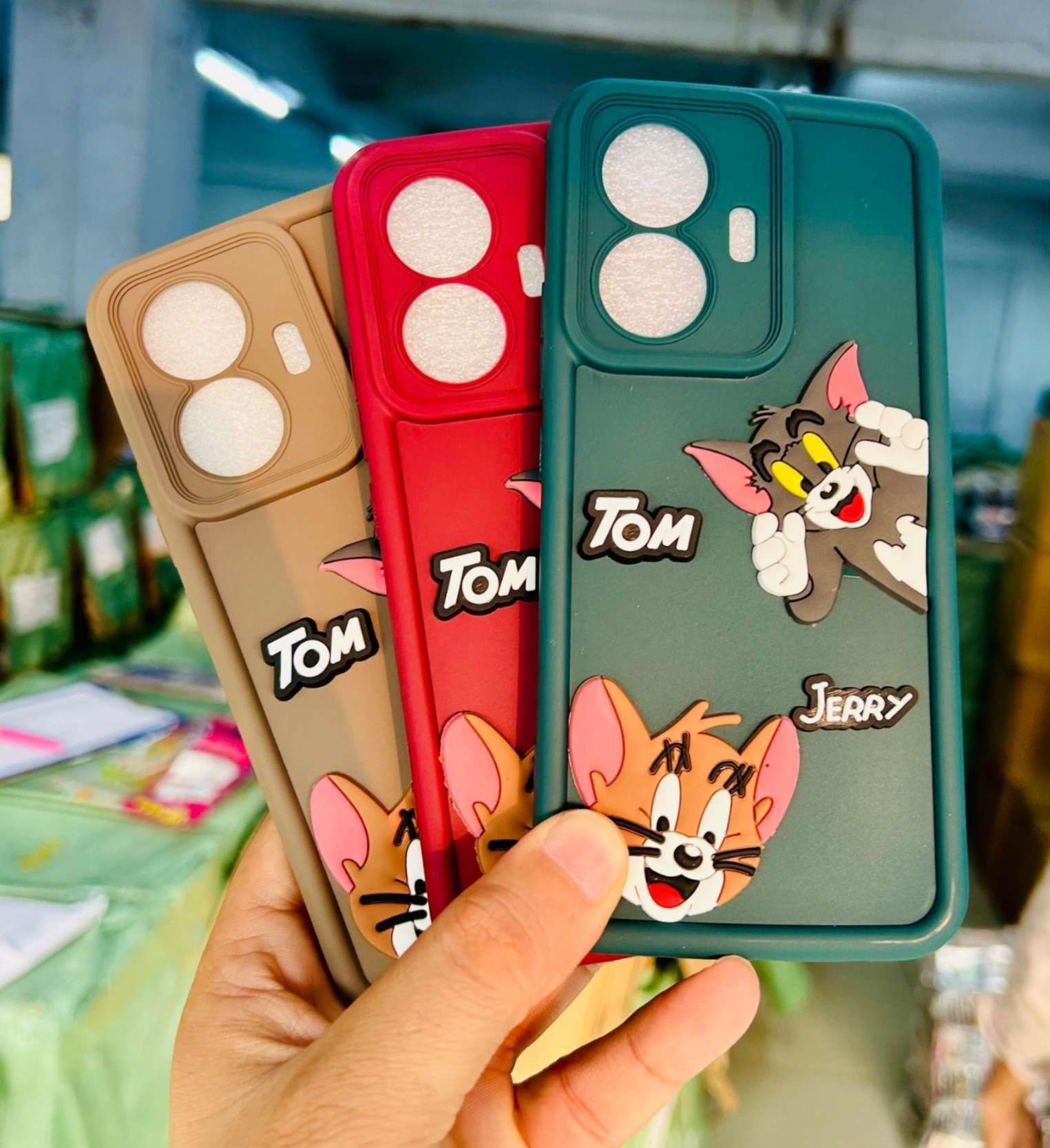 Printed cartoon mobile covers in maroon, brown and dark green for kids' segment retail